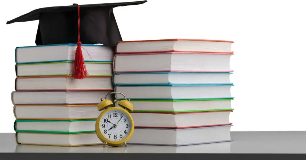 Graduation Cap on top of Colored Books